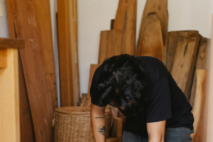 A man sitting to make floor boards