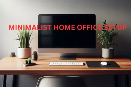 Modern minimalist desk setup with wooden desk, monitor, and plant.